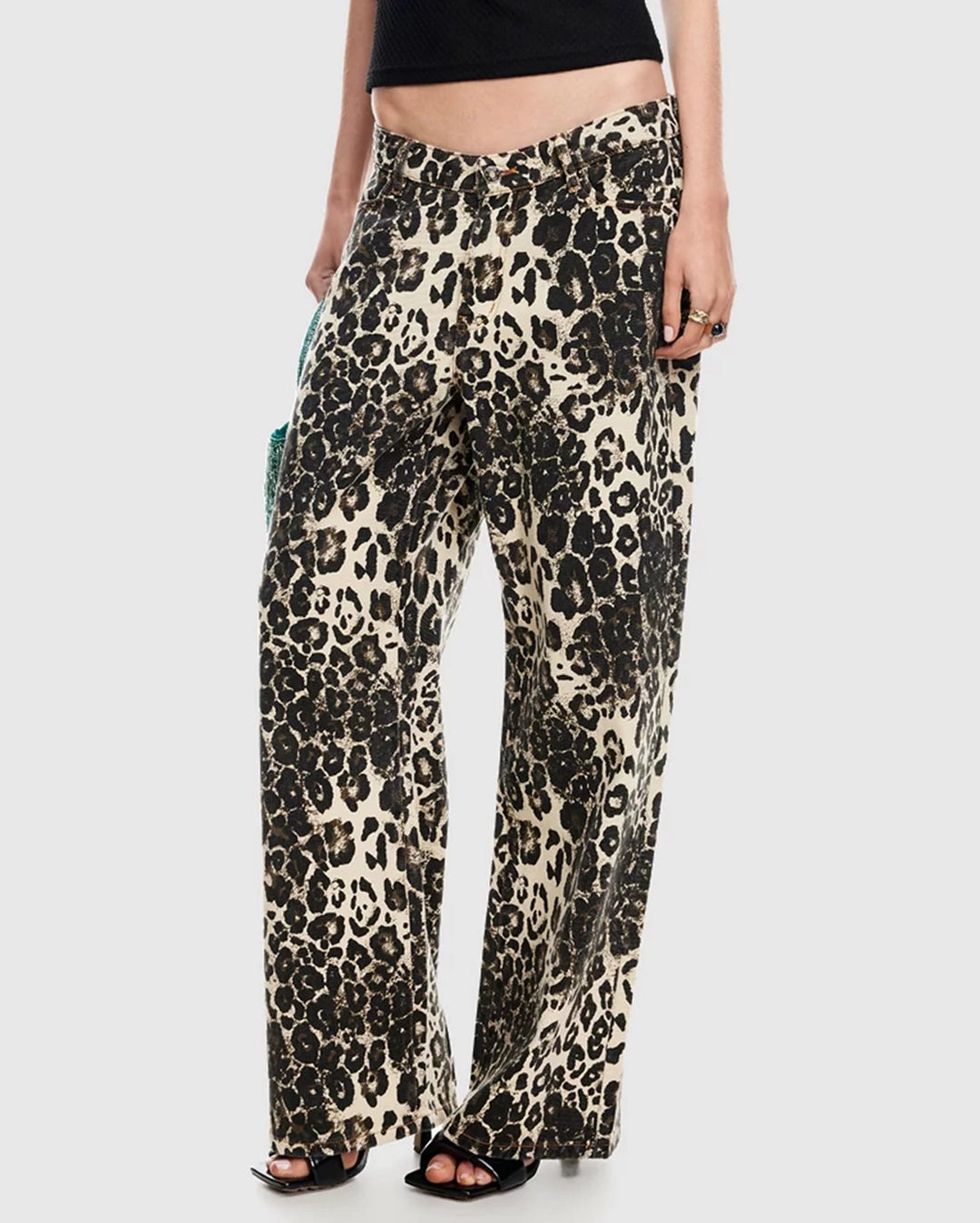 Leopard print pants worn by a person on a white background